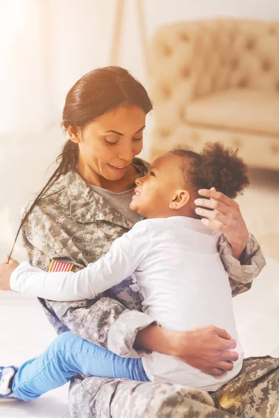 Gentle mother being about to caress her daughters hair — Stock Photo, Image