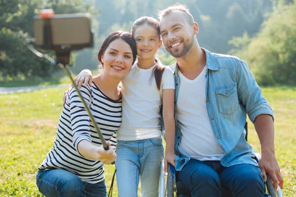 Família feliz tirando uma selfie juntos ao ar livre — Fotografia de Stock