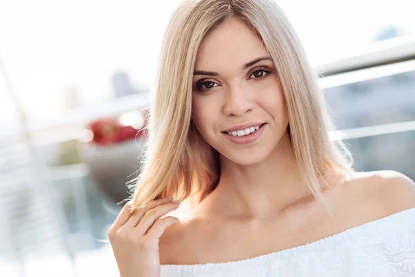 Beautiful charming woman touching her hair — Stock Photo, Image