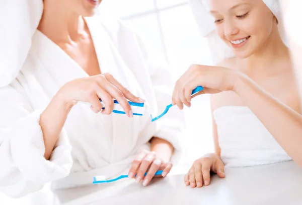 Delighted girl looking at toothpaste — Stock Photo, Image