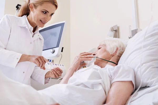 Brillante médico dulce dando a su paciente nuevas instrucciones — Foto de Stock