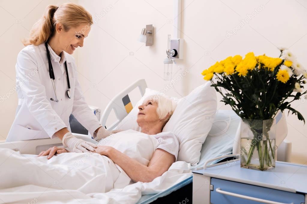 Charming qualified doctor giving her patient a nice prognosis