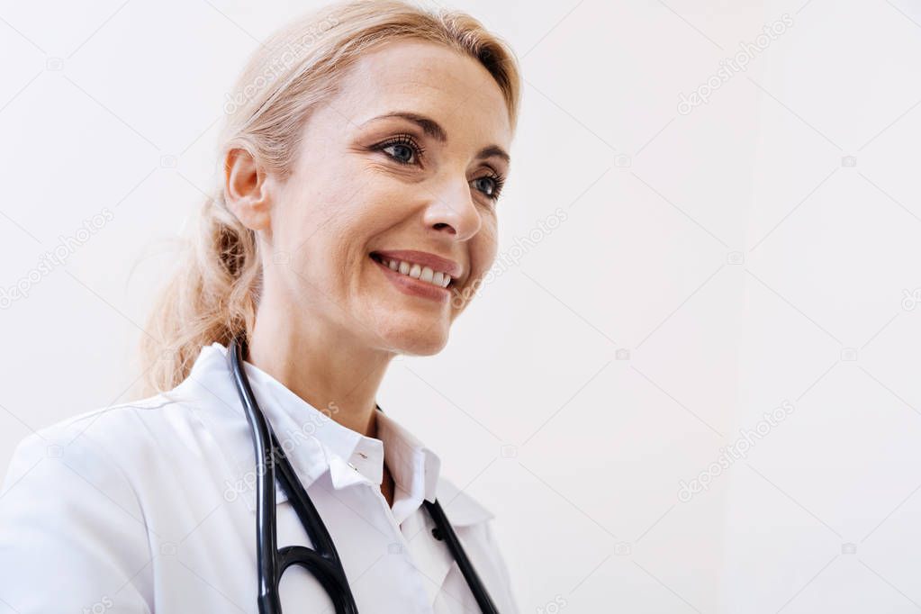 Bright prominent doctor consulting patient in her office