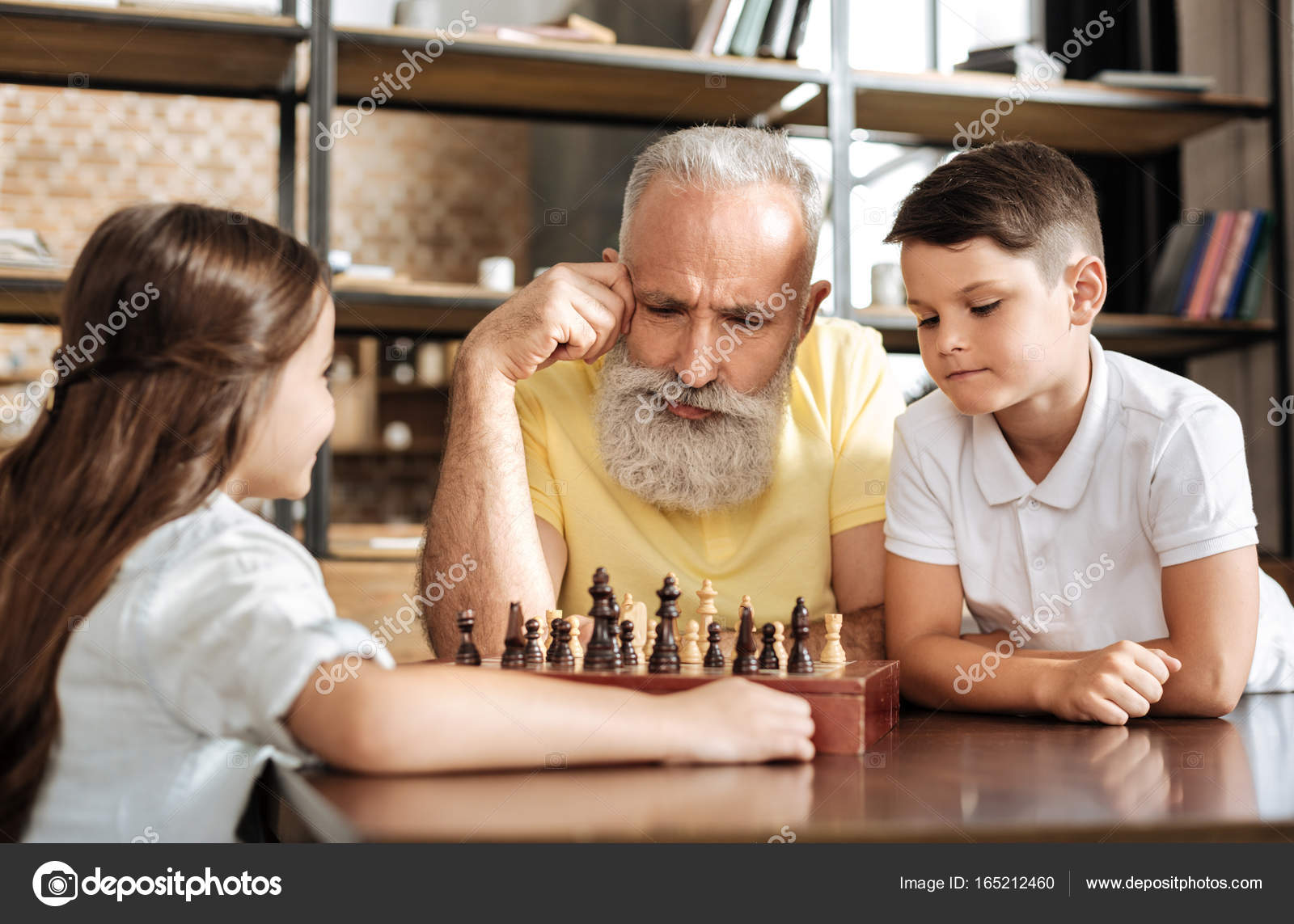 Smiling grandfather having idea about next chess move Stock Photo by  ©Dmyrto_Z 165212578