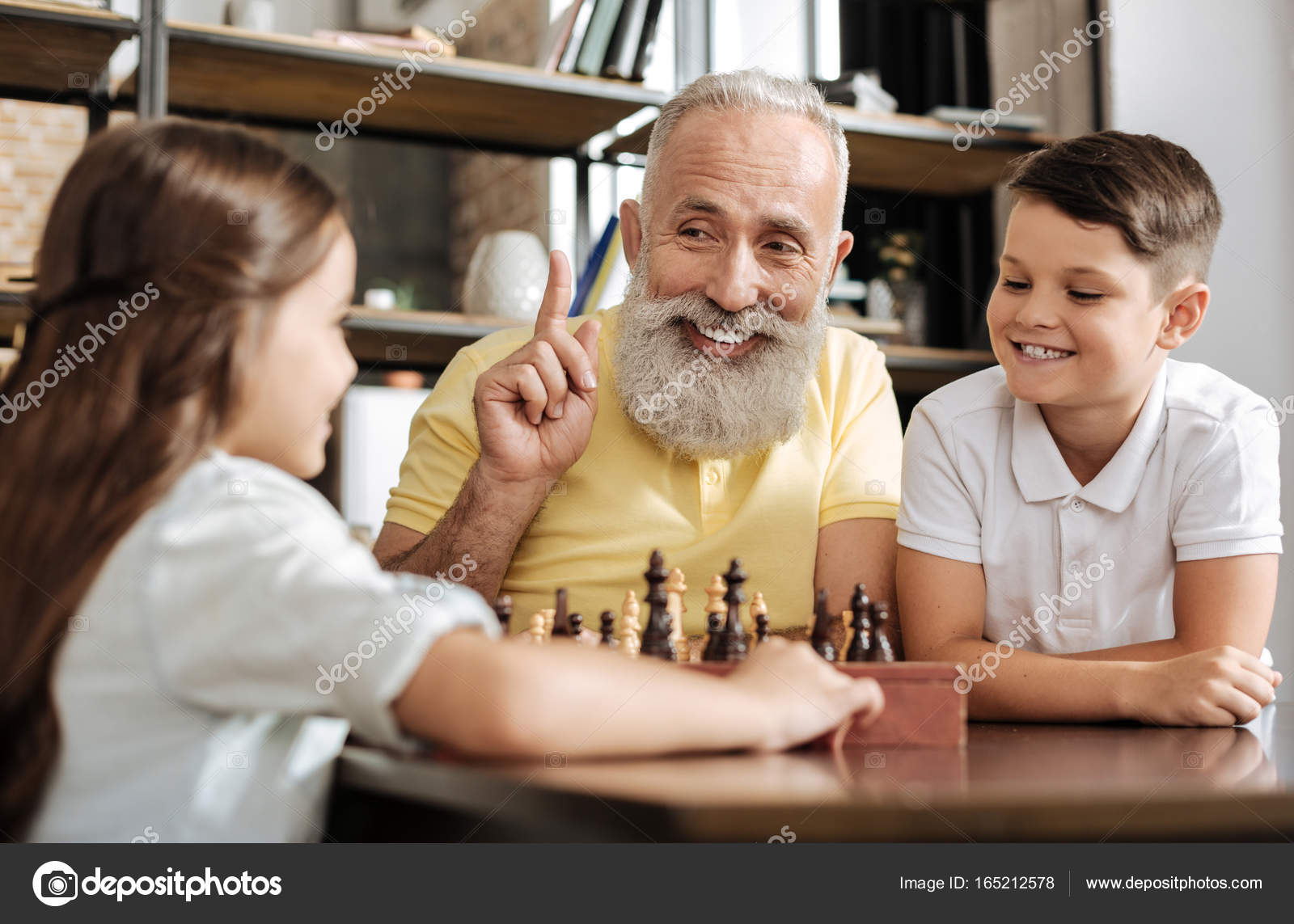 Smiling grandfather having idea about next chess move Stock Photo by  ©Dmyrto_Z 165212578