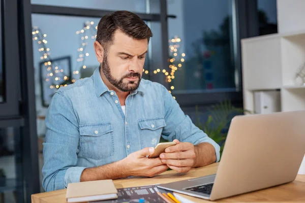 Sério homem perturbado verificando suas mensagens — Fotografia de Stock