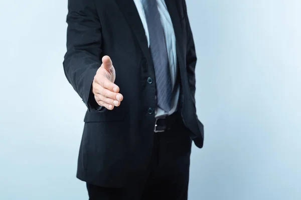 Nice pleasant man showing his hand — Stock Photo, Image