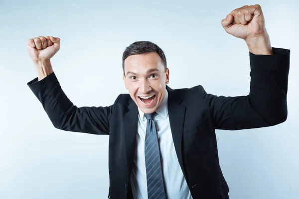 Joyful delighted man holding his arms up — Stock Photo, Image