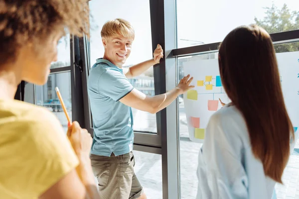 Joyful young colleagues working on the project in the office — Stock Photo, Image