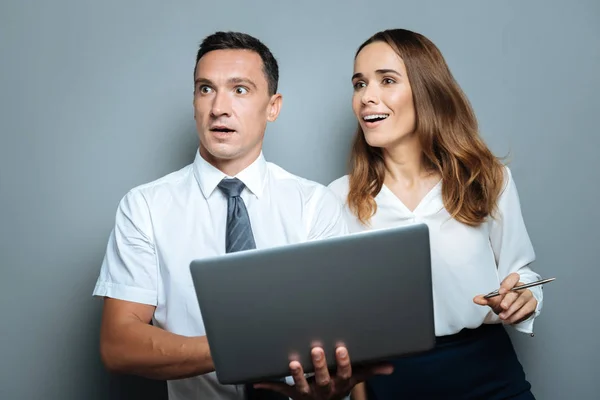 Positive nice colleagues looking surprised — Stock Photo, Image