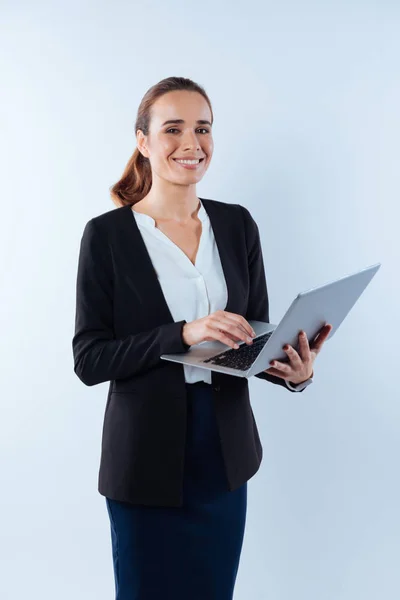 Delighted nice woman working on a laptop — Stock Photo, Image