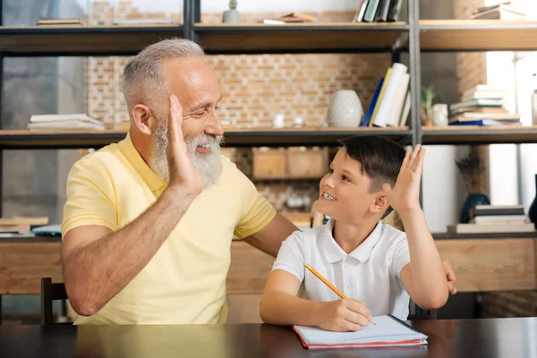 Grandfather and grandson giving each other high five — Stock Photo, Image