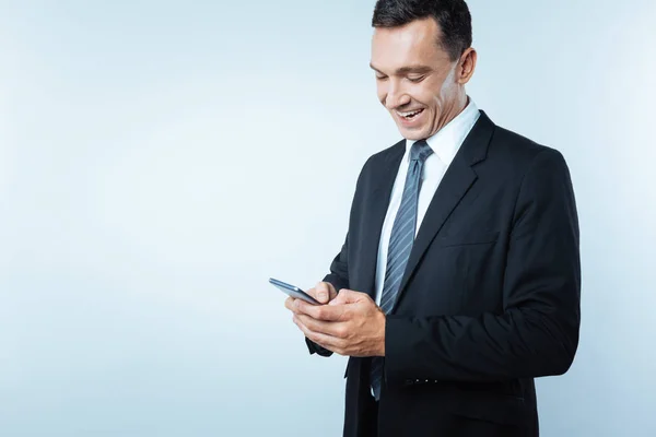 Joyful happy businessman typing a message — Stock Photo, Image