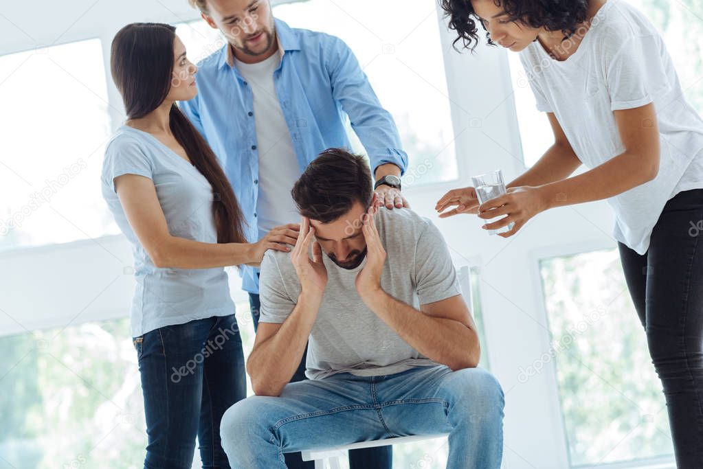 Cheerless bearded man having a migraine