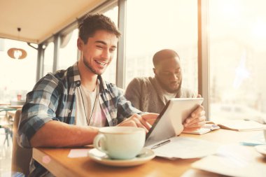 Kafeteryada oturan olumlu gülümseyen öğrenci