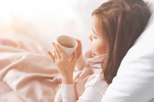 Profile photo of ill girl that siting in her bed — Stock Photo, Image