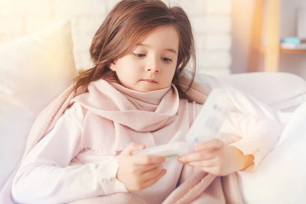 Upset little female person pressing her lips — Stock Photo, Image