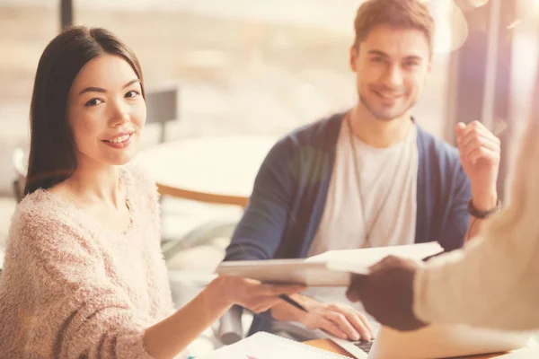 Positive colleagues sittign at the table — Stock Photo, Image