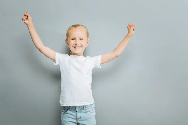 Encantada niña levantando los brazos — Foto de Stock