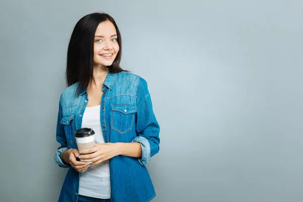 Positive delighted brunette holding cup with coffee — Stock Photo, Image