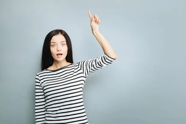 Surprised female raising her forefinger — Stock Photo, Image