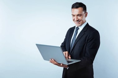 Neşeli işadamı bilgisayarda çalışarak