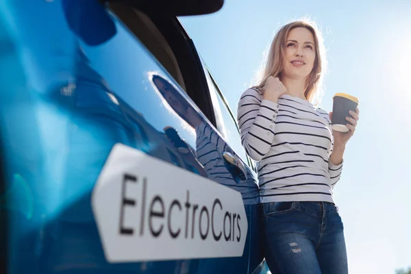 Pleasant blonde woman standing near the car — Stock Photo, Image