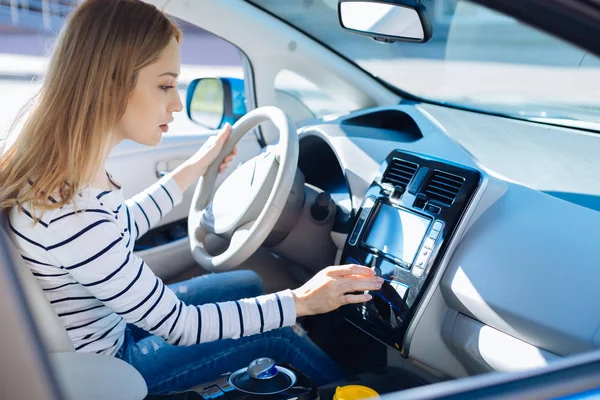 Nice pleasant woman starting her car — Stock Photo, Image