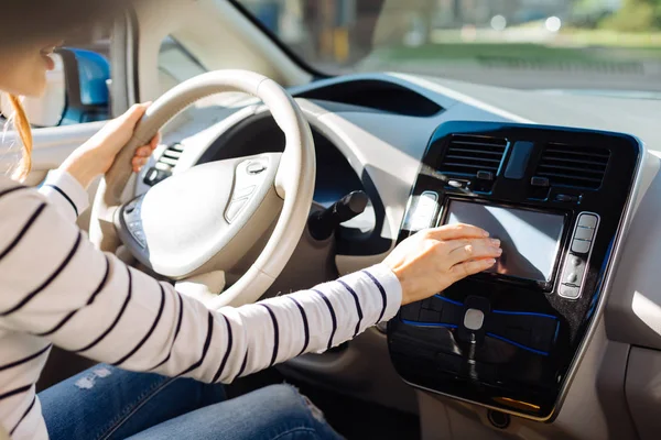 Nice young woman using the control panel — Stock Photo, Image