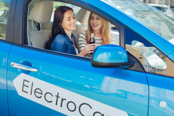 Delighted positive women sitting in the car — Stock Photo, Image