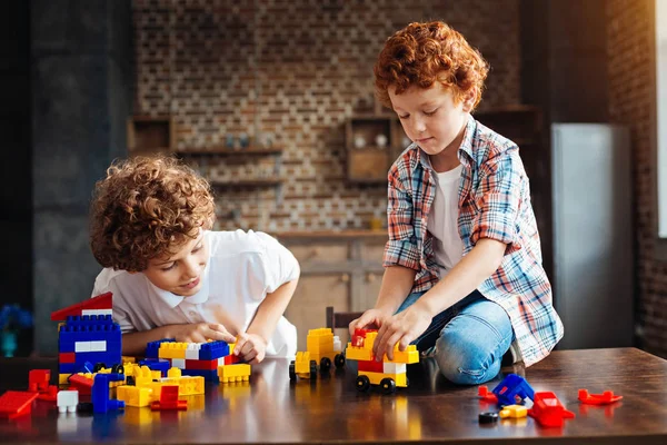 Hermano rizado jugando con bloques de construcción en casa — Foto de Stock