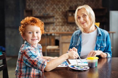 Neşeli küçük çocuk neşeyle kameraya gülümseyen