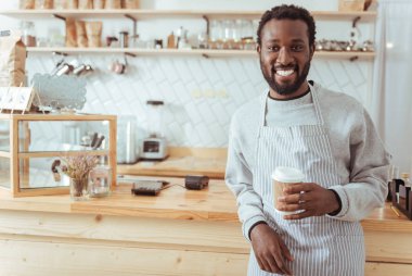 Bir fincan kahve ile poz barista gülümseyen