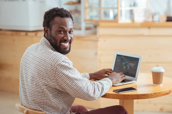 Hombre alegre sonriendo mientras se crea la presentación — Foto de Stock