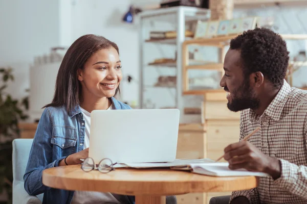 Pleasant colleagues discussing common project in cafe — Stock Photo, Image