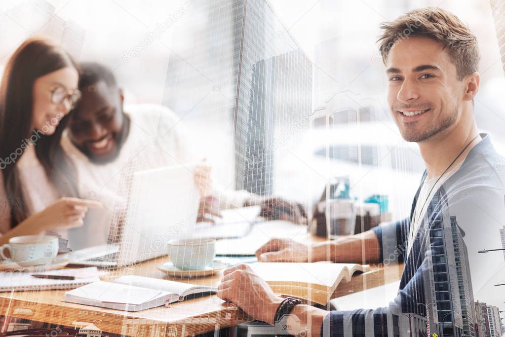 Close up of cheerful student holding a book