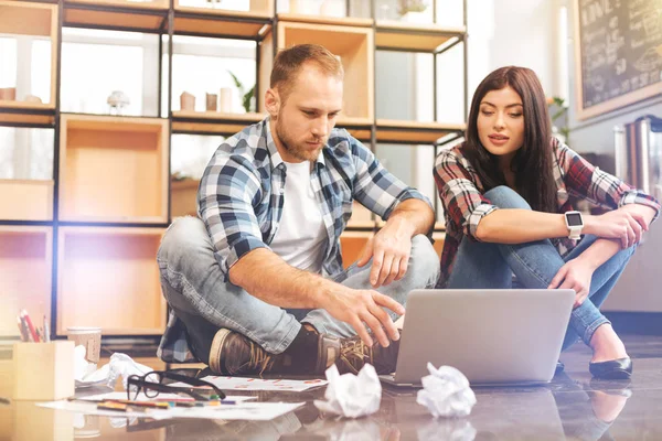 Jóvenes startuppers sentados en el suelo y trabajando — Foto de Stock