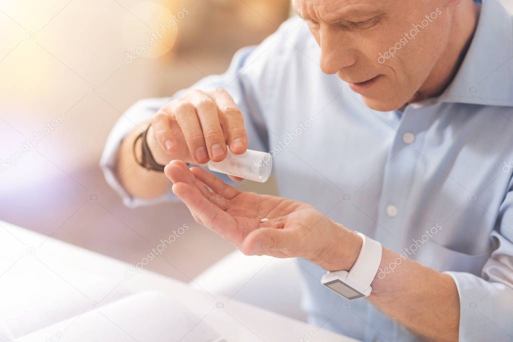 Unhealthy mature man taking pills
