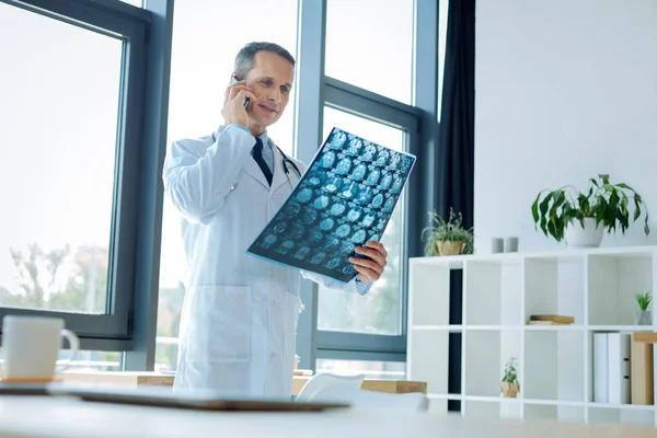 Ernstige knappe dokter praten aan de telefoon — Stockfoto