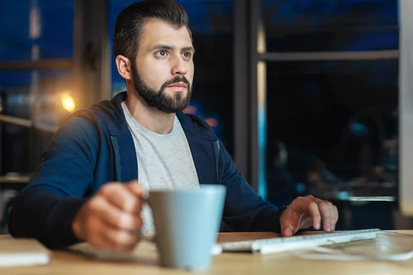 Handsome bearded man working at night — Stock Photo, Image