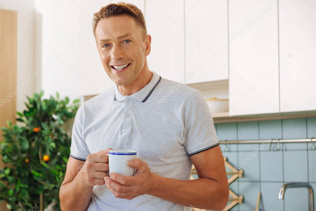 Happy delighted man resting at home