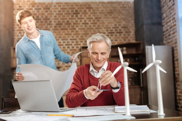 Senior man measuring distance on protractor with compass — Stock Photo, Image