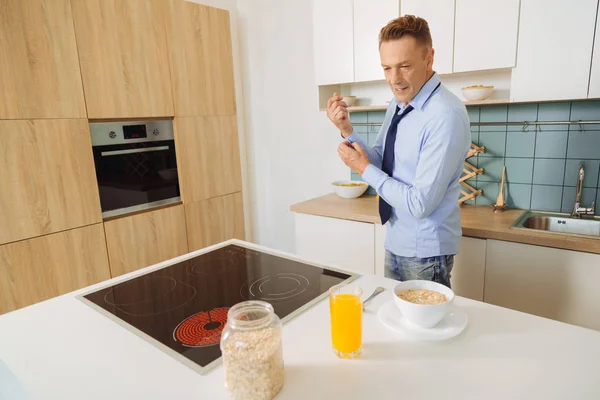 Nice positive man cooking food