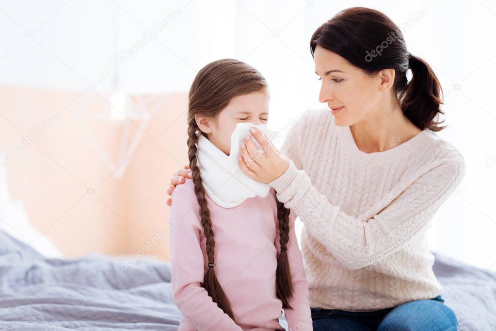 Kind woman holding a napkin for her daughter