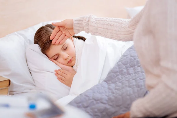 Little ill child sleeping peacefully in her bed — Stock Photo, Image