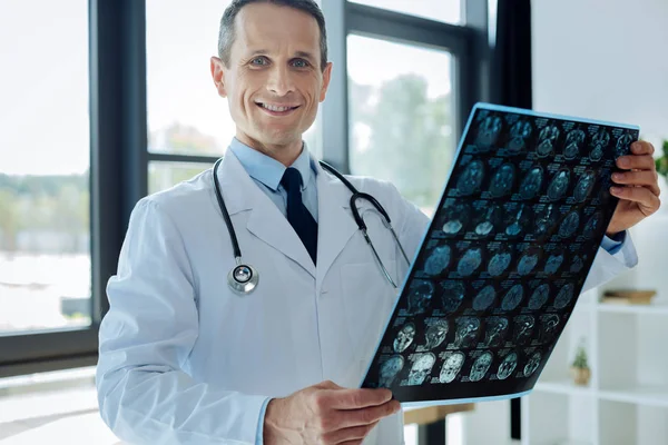 Handsome experienced neurologist studying an electroencephalogram — Stock Photo, Image