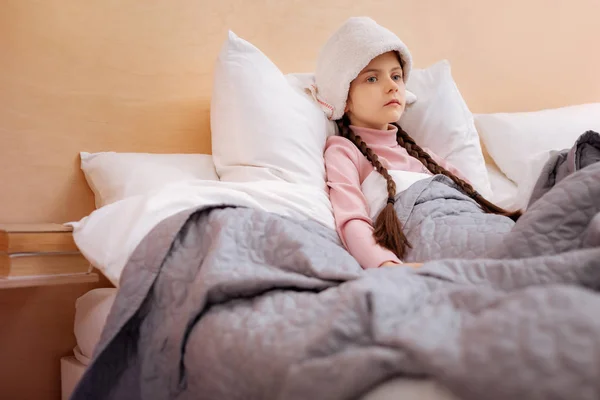 Sad girl sitting with a towel on her head — Stock Photo, Image