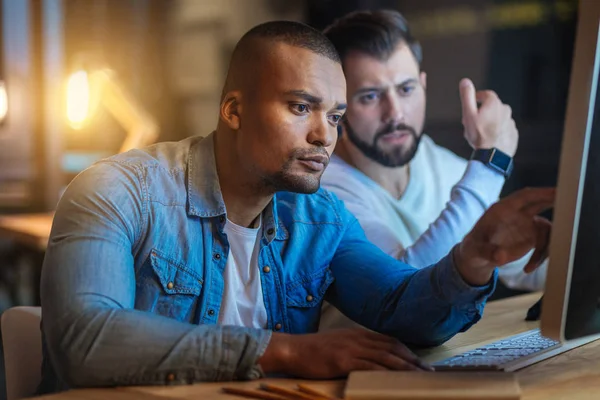 Handsome mulatto being concentrated on task — Stock Photo, Image