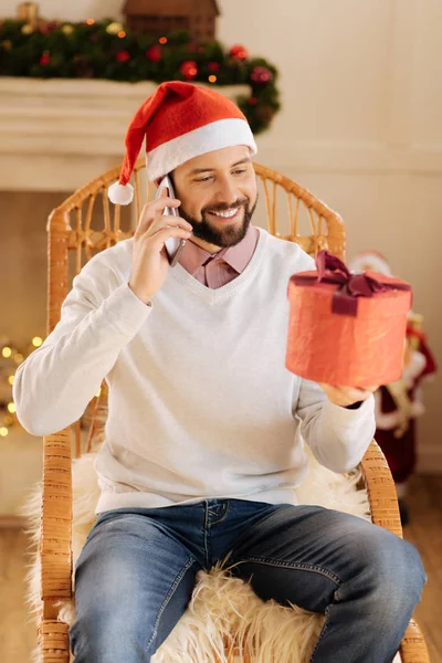 Pleasant man thanking for present on the phone