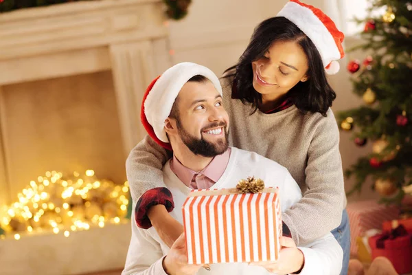 Loving wife hugging her husband and exchanging looks with him — Stock Photo, Image